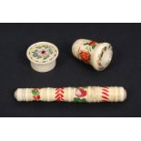 A painted bone needle case, a thimble case and a circular box, all brightly painted with flowers 9.