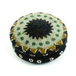 A good beadwork covered circular horn box, circa 1840, the lid with a geometric design in coloured