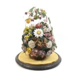 An early Victorian group of shellwork and paper flowers and leaves arranged in a cane work basket,
