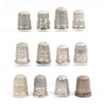 Twelve English silver thimbles all with decorative borders, all hall marked (12)