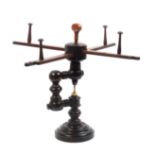 A 19th Century turned hardwood wool winder or swift on circular base with bone inset to stem, 35cm