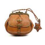 A mid 19th Century brown leather bag form sewing companion for a child, engraved gilt brass clasp