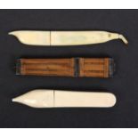 Three needle cases comprising a 19th Century ivory example as a slipper, 8cm, another 19th Century