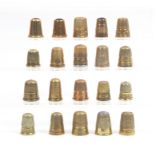 Twenty brass thimbles some with inscribed or decorative friezes, four with coloured tops (20)