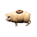 A 19th Century carved ivory pin cushion in the form of a standing pig, slight loss to tail, some