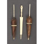 Three umbrella form needle cases comprising a bone example with inoperative Stanhope, 13cm, and