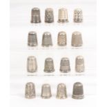 Sixteen mostly plain border English silver thimbles, all hall marked (16)