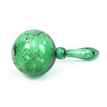 An unusual green glass ball form darner with cut and etched decoration of flowers and inscribed '