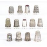 Thirteen continental white metal thimbles mostly with decorative borders including two modern Danish