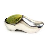 A silver pin cushion in the form of a Dutch clog, Birmingham, 1908 by Walker and Hall, 10cm