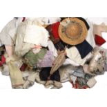 A wicker pannier containing vintage dolls clothes, lace trimmings, straw hat, parasol (qty)
