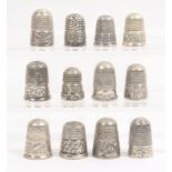 Twelve English silver thimbles all with decorative borders, all hall marked (12)