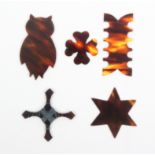 Five tortoiseshell silk winders comprising an owl, 5.5cm, a multiple, 5.2cm, a star, 4.5cm, and