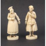 A pair of 19th Century carved ivory Dieppe figures of a fisherman in traditional costume holding a