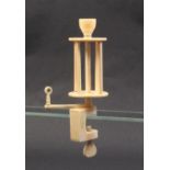 An unusual 19th Century ivory winding clamp the rectangular frame below a rotating arm with eye