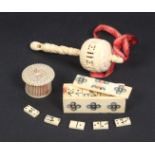 Three bone items comprising a turned and pierced baby rattle, 12.5cm, a set of miniature bone
