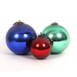 Three antique glass witches balls in blue, green and red, largest, 15cm (3)