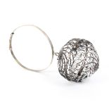 An early 19th Century continental silver wool ball holder the hinged ball form cage with spiral