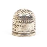 A 17th Century English silver thimble, the vacant rectangular cartouche with a makers mark, probably