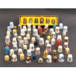 A collection of modern ceramic thimbles together with others and a cased set of six demonstrating