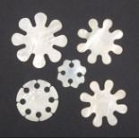 Five Chinese mother of pearl silk winders comprising three of snowflake form and two circular