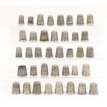 Thirty eight white metal thimbles some with decorative borders (38)