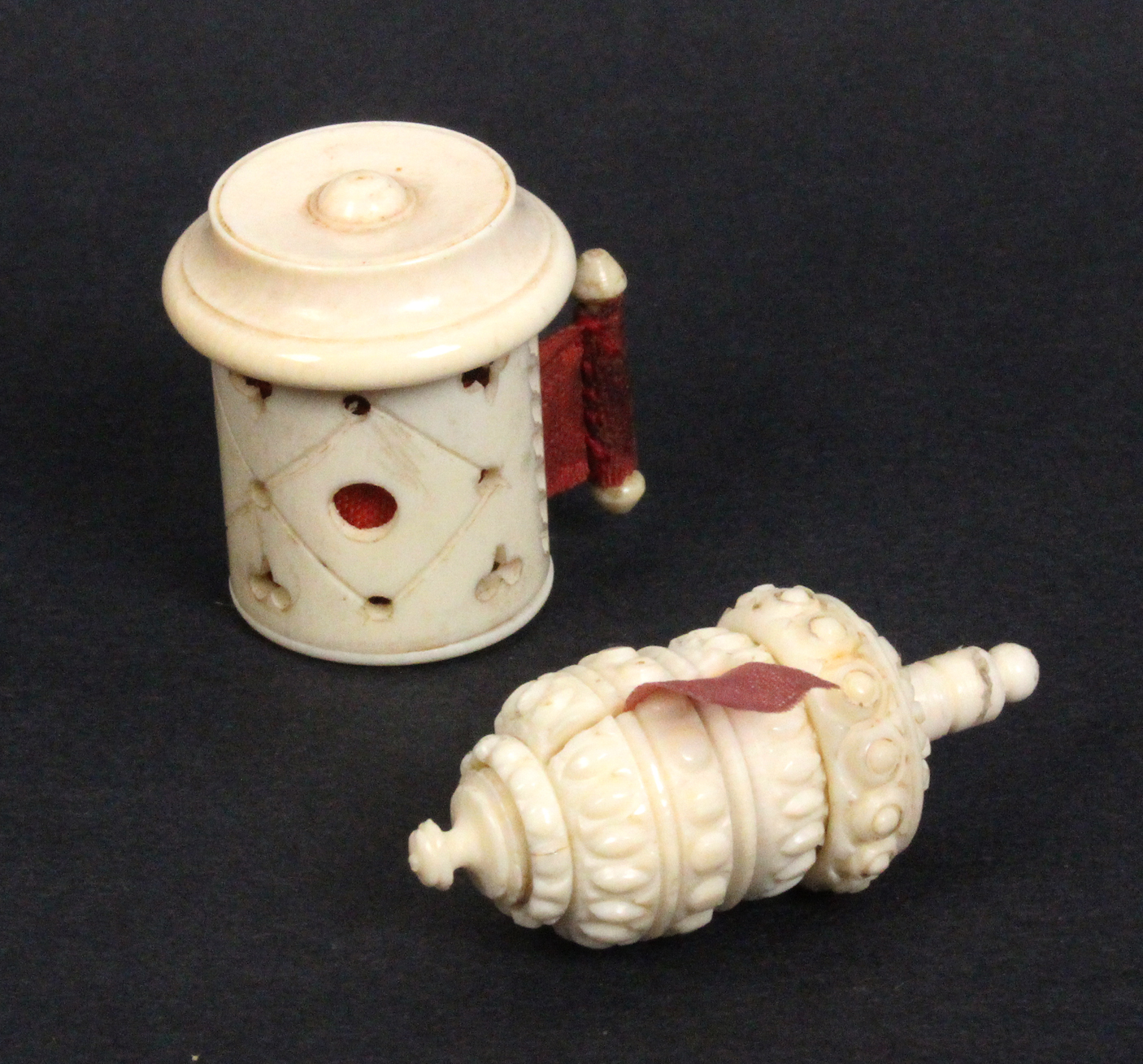 Two 19th Century ivory tape measures comprising a cylinder example with roundel top, pierced