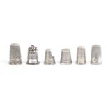 Six English silver thimbles including three tall 19th Century examples with decorative borders, a
