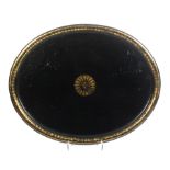 A large mid-19th Century oval papier mache tray with central gilt motif and edge border, 71.5cm