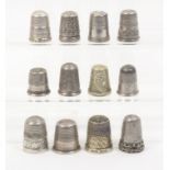 Twelve thimbles comprising nine silver examples including a steel top and three others (12)