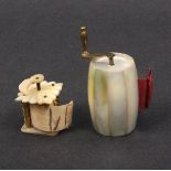 Two tape measures comprising a barrel form mother of pearl example with brass coffee grinder handle,