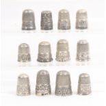 Twelve English silver thimbles all with decorative borders, all hall marked (12)