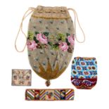 Bags and accoutrements comprising a floral decorated drawstring beadwork bag with strawberry base
