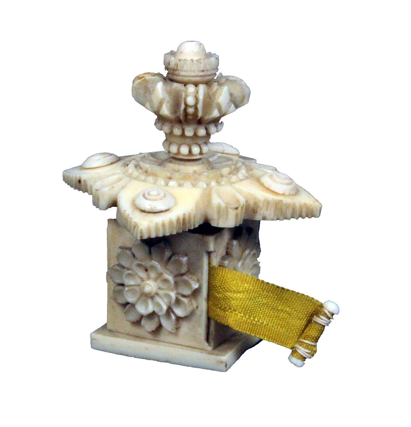 An elaborate 19th Century ivory tape measure of square form the sides carved with flowers, the