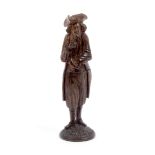 A well carved standing figural wooden needle case, probably Black Forest, the circular base