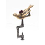 A steel and brass hemming bird sewing clamp, rectangular frame, the sprung bird with pin cushion,