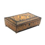 A Regency penwork card box of sarcophagal form the sides decorated with flowers, leaves and birds,