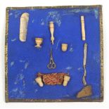 A rare card of bone and other sewing accessories and related items for a doll, the blue card with