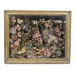 An early 19th Century shell work and paper garden in glazed case centered by a shell decorated