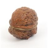 A natural walnut etui for a doll or child, circa 1850, gilt brass hinged rim to a plain gilt mount