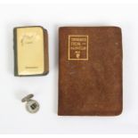 Three miniature books comprising The Lords Prayer in various languages, black leather cover with