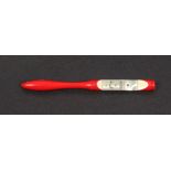 A 19th Century red stained ivory needle threader the white metal plaque inscribed 'J. Rodgers And