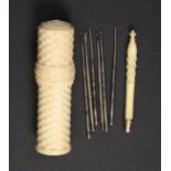 A 19th Century ivory tambour or crochet set the cylinder case of stacked brick form, the handle of