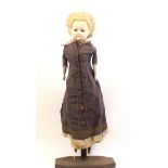 A Victorian wax head doll, glass eyes, cloth body with painted wooden lower limbs and arms, in