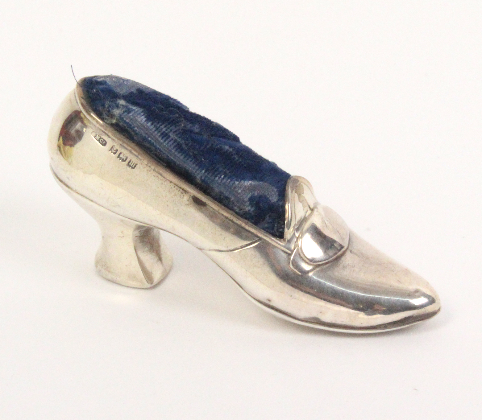 A silver pin cushion in the form of a lady's shoe, oval buckle, Birmingham 1911, makers mark not