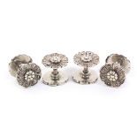 A rare set of four Victorian cast silver reel holders, each end cast as a flowerhead united by screw