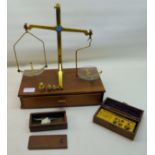 A set of travelling brass balance Scales by P J Thornton on a single drawer stand, together with