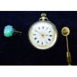 An open face Fob Watch with jewelled dial in engraved silver case, a gold Dress Ring set with an