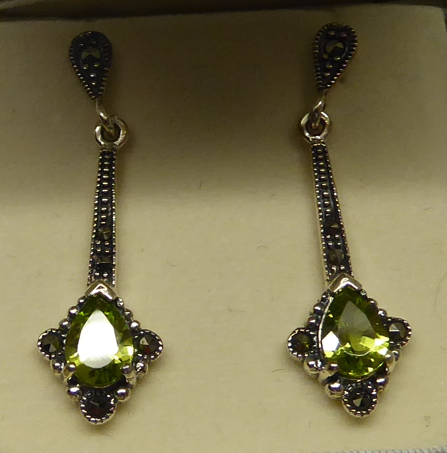 A pair of silver pendant Earrings set with peridot and marcasite.