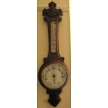An aneroid Barometer and Thermometer the dial inscribed J Leadbeater, Rotherham, in carved oak banjo
